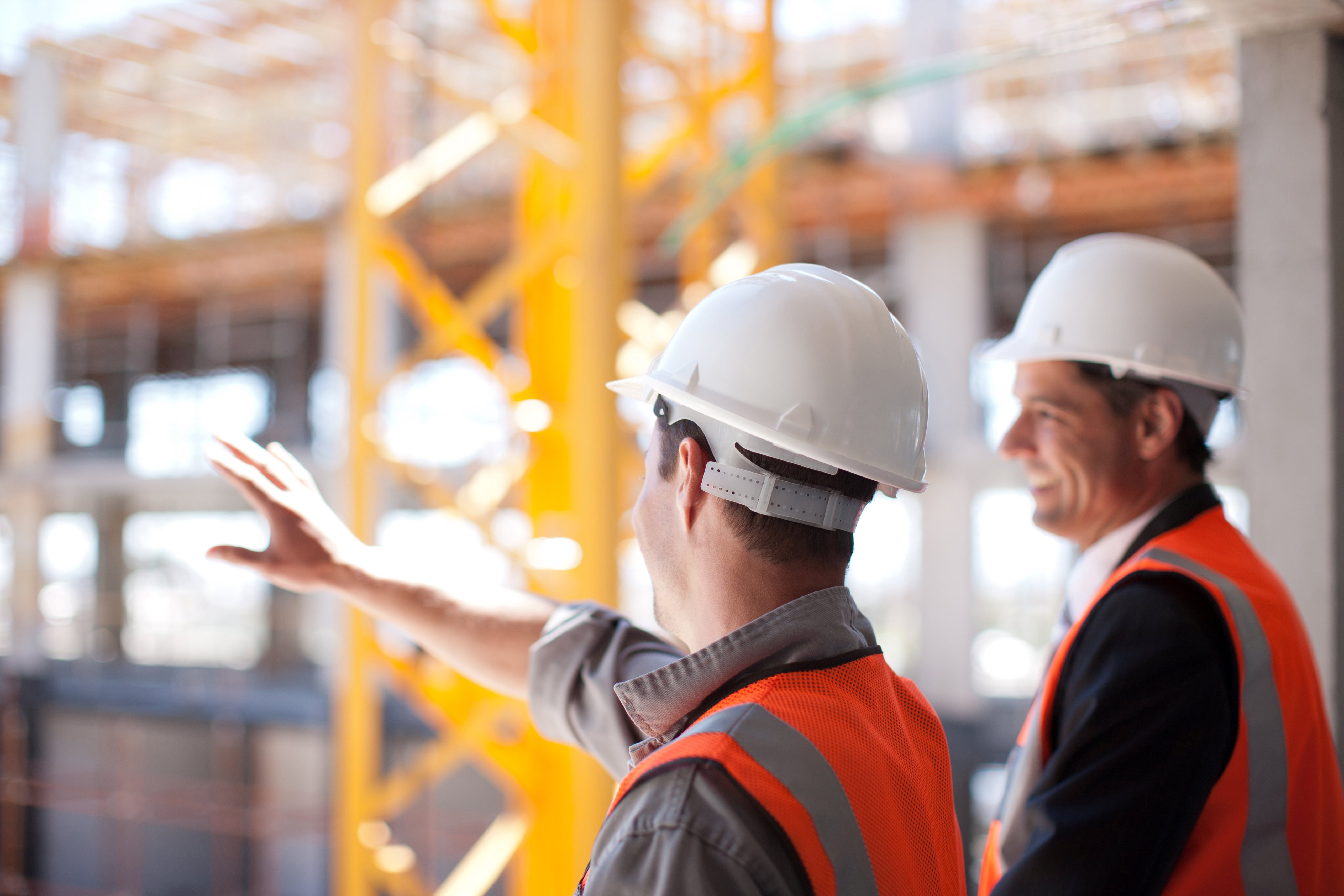 Two men overlooking construction site Two men overlooking construction site