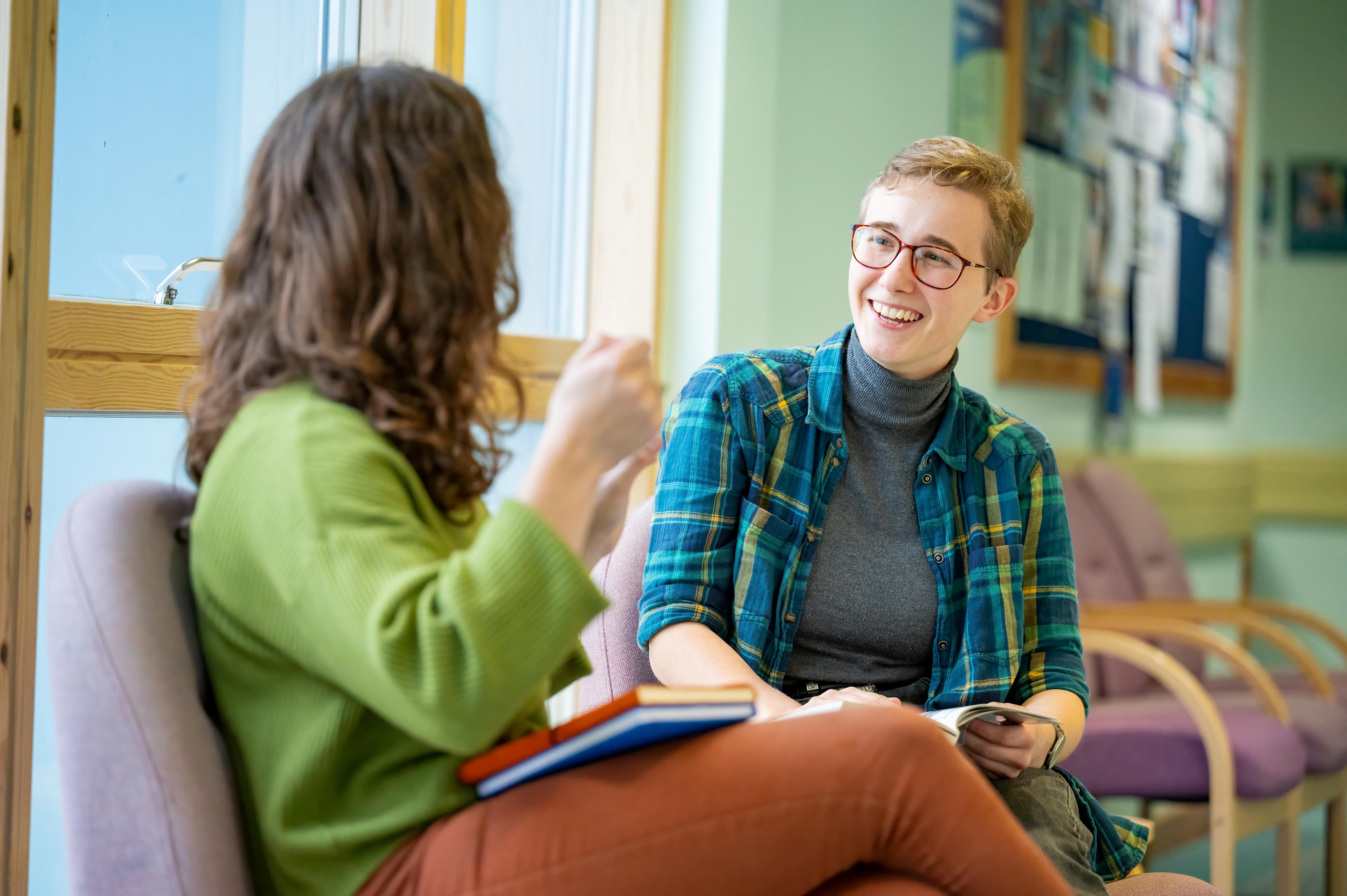 Two students conversing and smiling Two students conversing and smiling