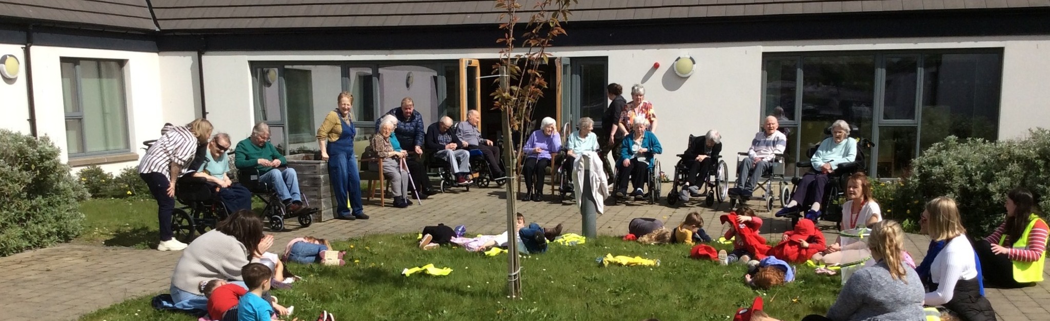 Retirees spending time with young children at the care home