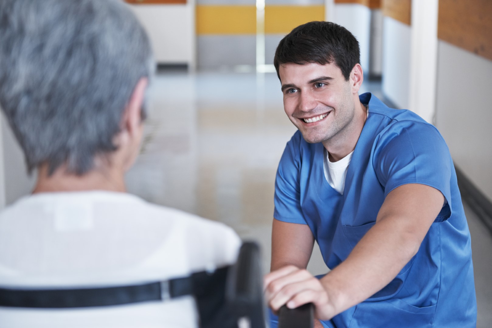 A healthcare worker and an older person talking