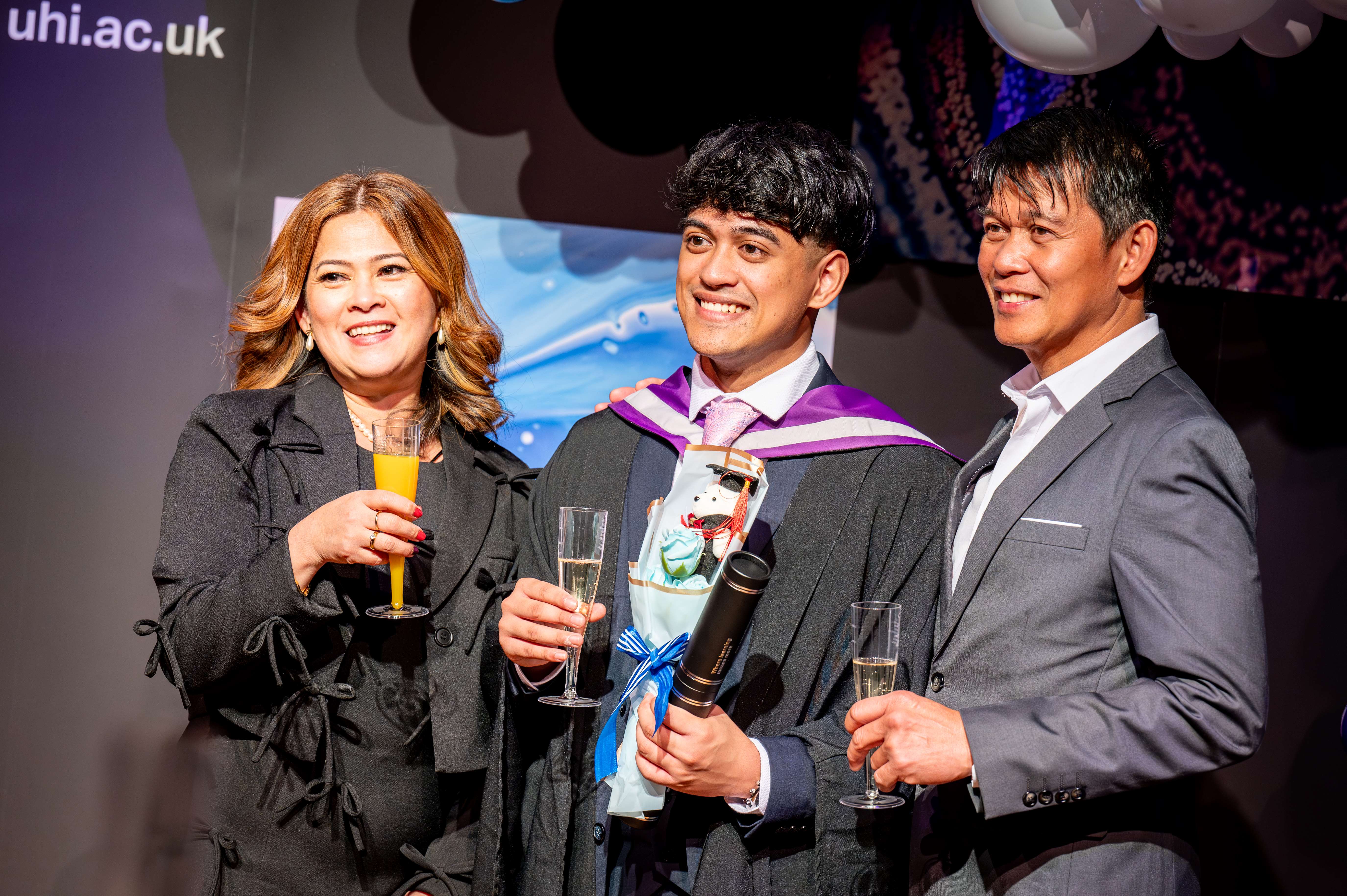 Graduate celebrating with his parents