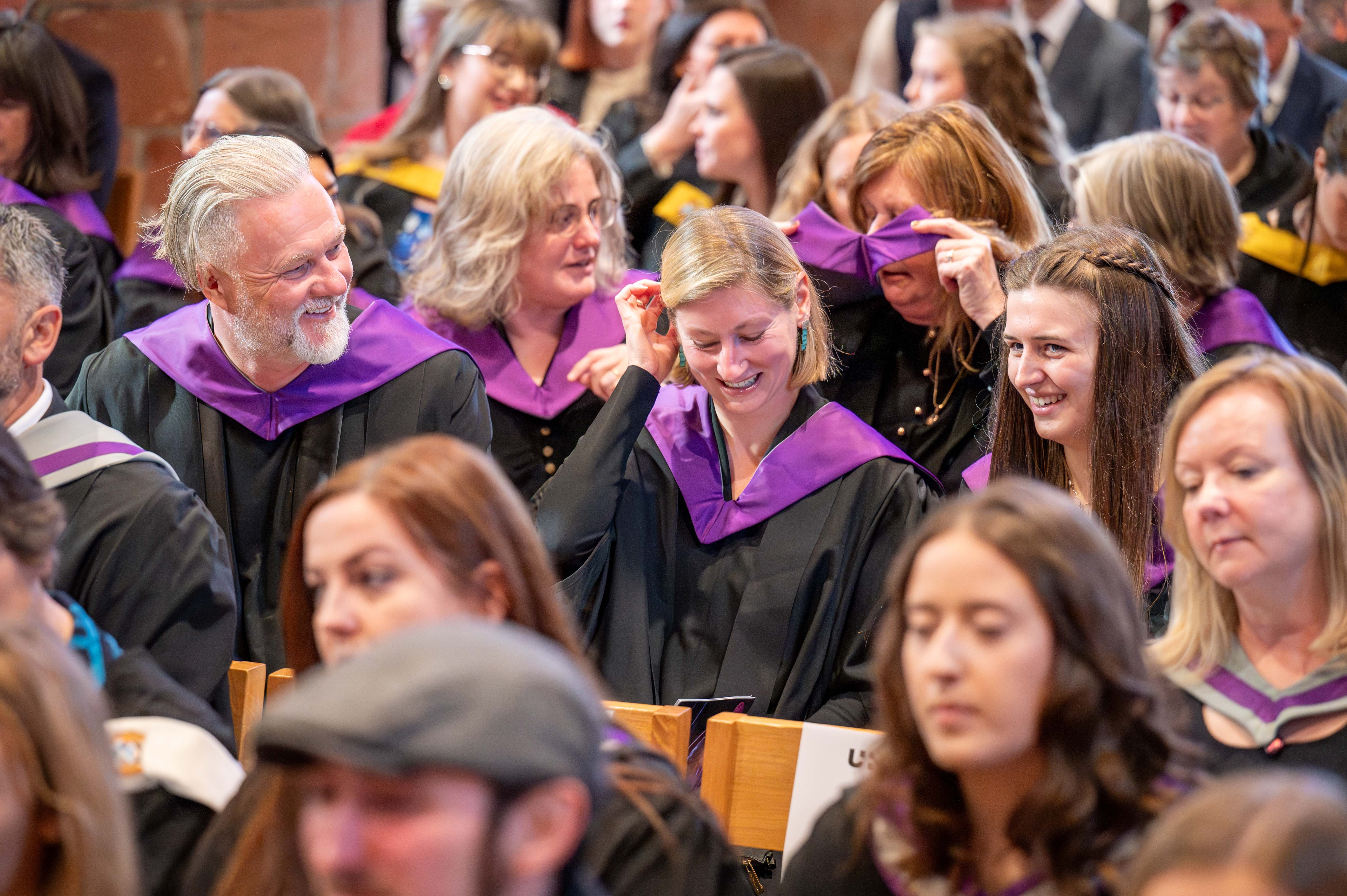 Students in the crowd seated at graduation