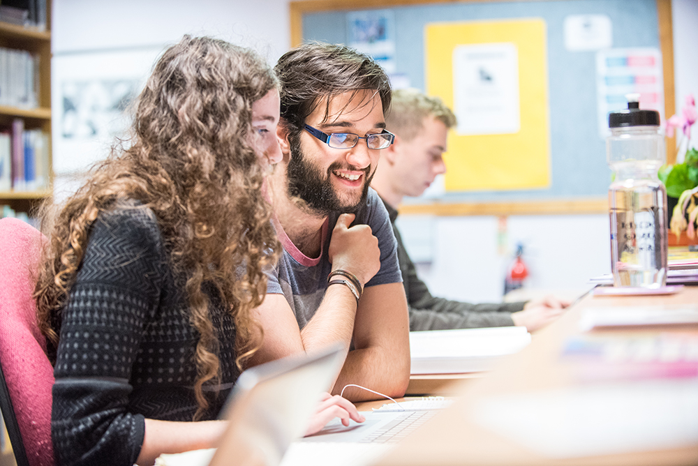 Students talking in a library