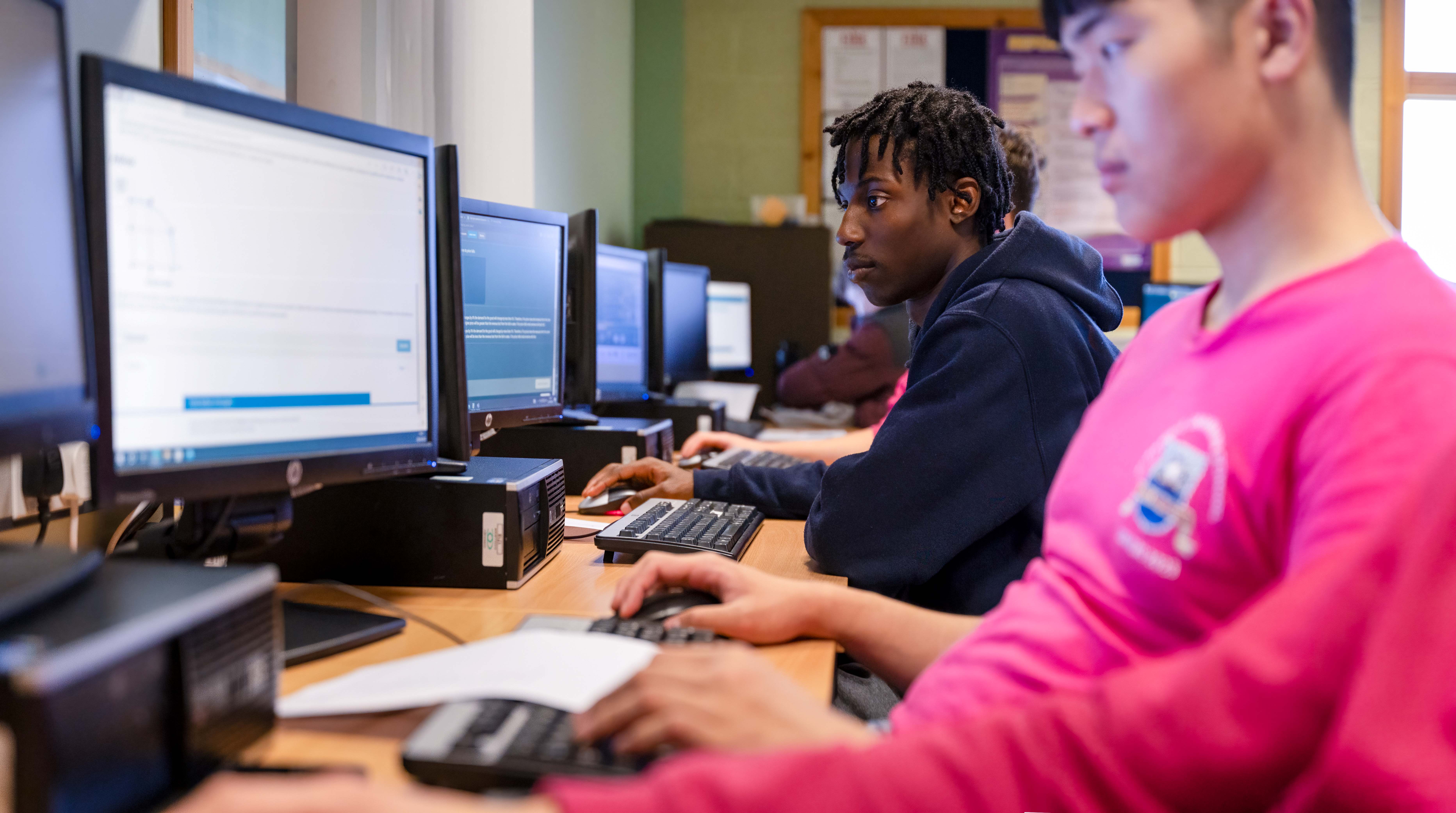 Male students using computer Male students using computer