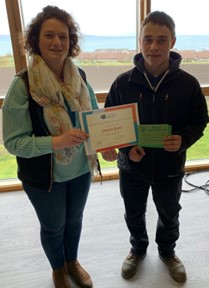 Most improved student Charlie Scott receives award from instructor Jo Higgs