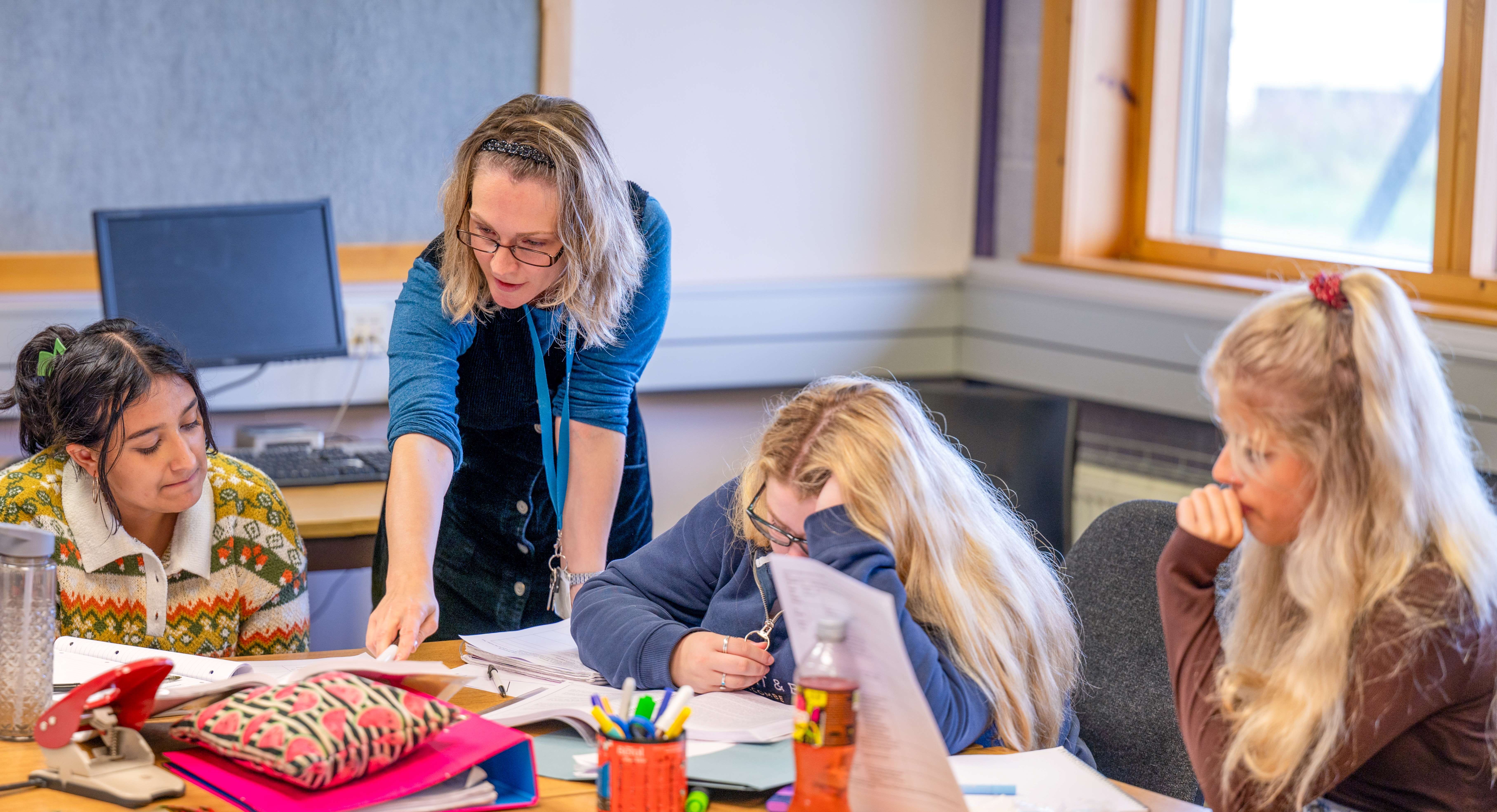 Lecturer helping students with their work